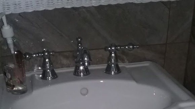Installation of pedestal sink and faucet Photo